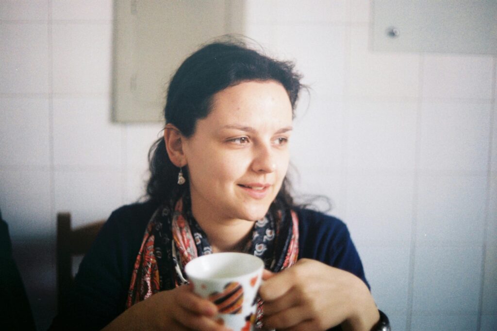 pexels-photo-32171834-32171834 A young woman enjoying a cup of coffee indoors, captured in natural light.